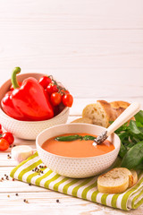 Italian tomato soup gazpacho with basil, tomatoes and baguette