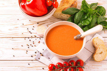 Italian tomato soup gazpacho with basil, tomatoes and baguette