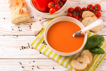 Italian tomato soup gazpacho with basil, tomatoes and baguette