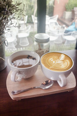 Coffee cup and tea cup in coffee shop - vintage tone hipster style 