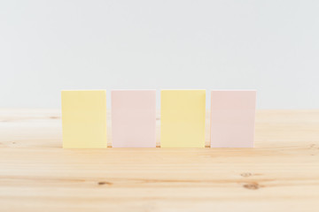 color blank sticky notes on wooden desk