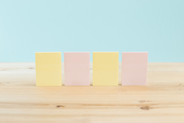 color blank sticky notes on wooden desk