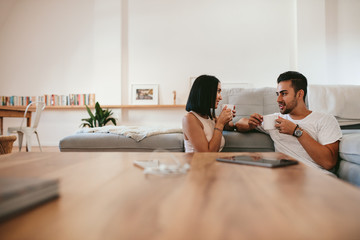 Young couple having coffee at home