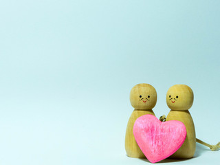 a gay wooden couple on a soft background customizable e.g. for st valentine day or for a wedding anniversary