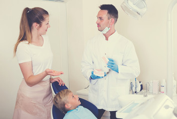 Girl is consulting with dentist about her child`s health