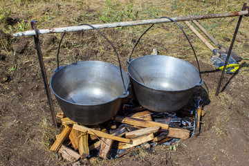 Cooking plov in the cauldron. Only the meat in the cauldron. Field kitchen. Eastern cuisine.