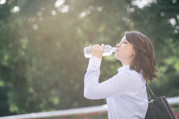hydration concept. a young woman drinking a bottle of water.
