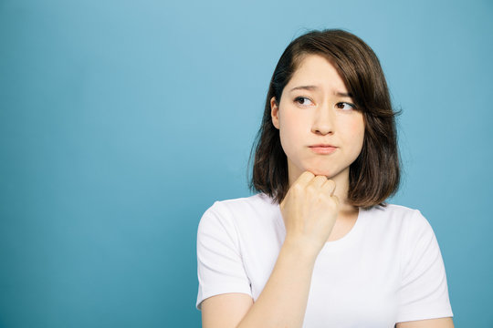woman thinking on blue background.