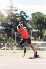 Disabled man athlete training with leg prosthesis.