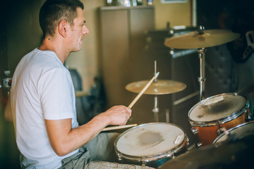 Behind scene. Drummer artist musician playing the drums with drumsticks