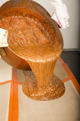 Brown caramel in copper pan ready, dispensing pourring on the pads
