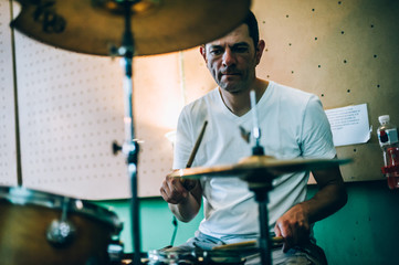 Behind scene. Drummer artist musician playing the drums with drumsticks