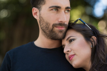 Fototapeta premium Young pensive couple cuddling together