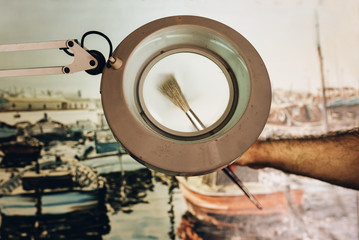 Close up of man artist painting oils in his studio.