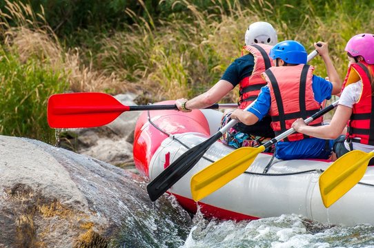 Rafting. Close-up view of oars with splashing water.