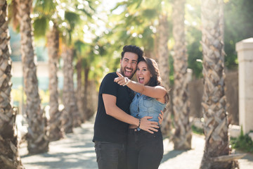 Fototapeta premium Happy couple standing together outside looking away