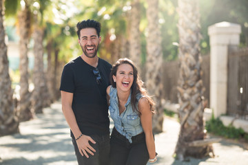 Fototapeta premium Happy couple standing together outside having fun