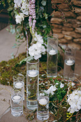Original wedding floral decoration in the form of mini-vases and bouquets of flowers hanging from the ceiling