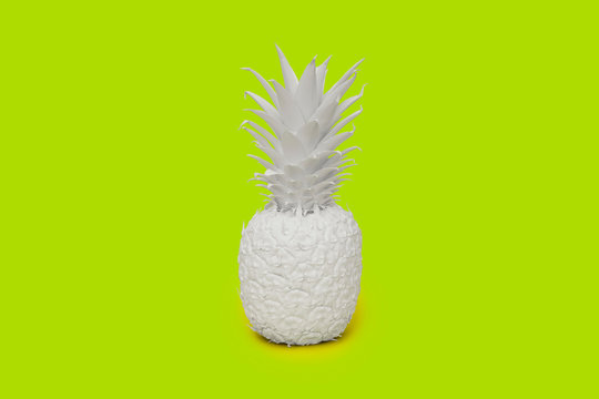 Pineapple painted white on lime green background