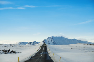 Landscaped the road in winter, with a cars driving on highway in Iceland