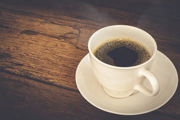 hot coffee on old wooden table