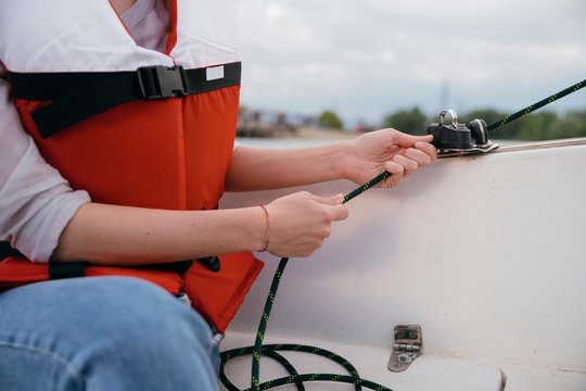 Woman on sailing boat, steering boat, close-up