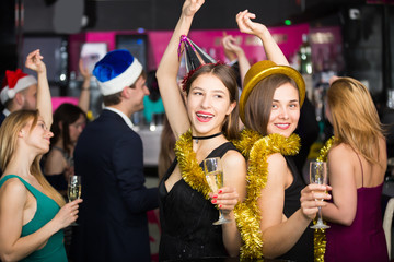 Fototapeta na wymiar Cheerful females and males celebrating new year