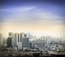 Fototapeta na wymiar Seoul cityscapes sunset lighting effect, skyline, high rise office buildings and skyscrapers in Seoul city, winter daylight, top view in winter, Seoul, Republic of Korea, in mist