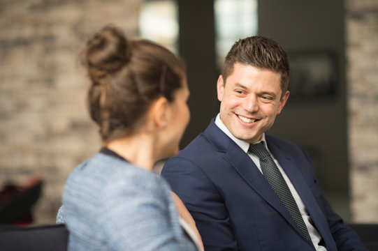Businessman and woman meeting on office sofa