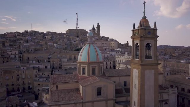 flying past dome of San Giuliano cathedral towards Caltagirone