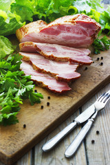 Slices of bacon on the wooden background. Brisket