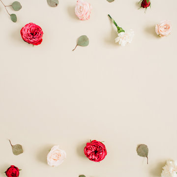Fototapeta Flowers frame made of beige and red roses, eucalyptus leaf on pale pastel beige background. Flat lay, top view. Floral wreath frame background.