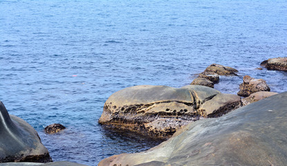 Fototapeta na wymiar The beautiful rock on the sea background