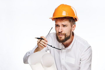 Engineer with a beard on a white isolated background holds a drawing