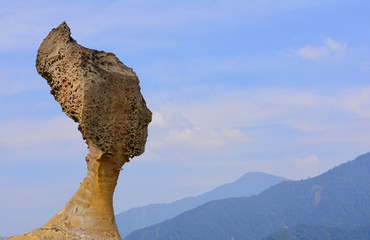 Queen Rock in Yehliu Geopark, Taiwan on the blue sky and Mountain