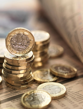 Still life of British currency on financial newspaper, close-up