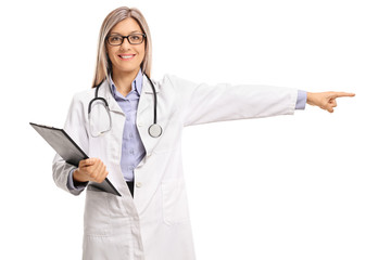 Female doctor holding a clipboard and pointing right