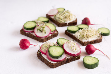 Tasty healthy sandwich Rye sandwich with radish cucumber Copy space Healthy breakfast