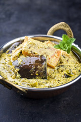 Traditional Indian Vegetable Curry with Sweet Potatoes and Eggplant as close-up in a Korai