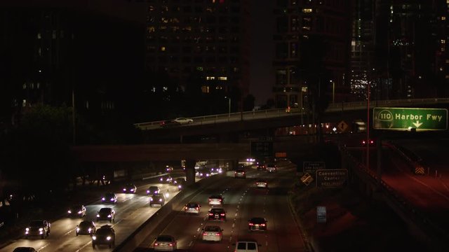 Freeway traffic in downtown Los Angeles at night. Evening Rush Hour Traffic. 4K