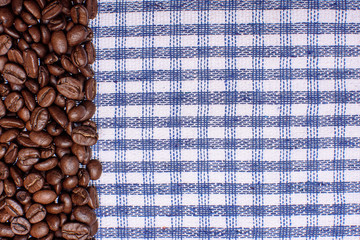 Texture of a colored towel, a towel of a cellular type, on which lies a certain amount of brown...