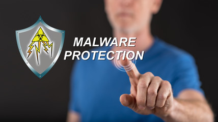 Man touching a malware protection concept on a touch screen