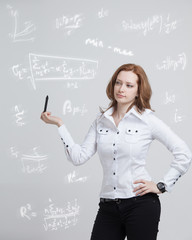 Woman scientist or student with pen working with various high school maths and science formula.