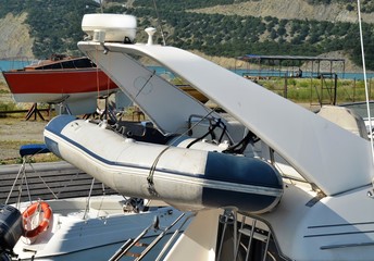 Fototapeta na wymiar Rescue inflatable boat fixed on sea yacht