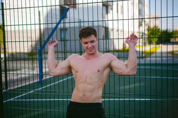 Handsome sexy male bodybuilder athlete man with naked torso, Poses showing a powerful muscular body...