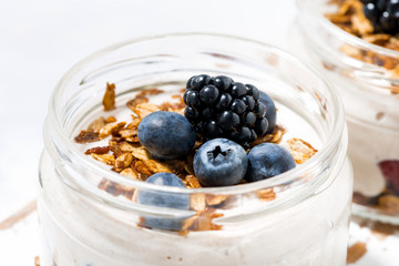 healthy creamy dessert with berries in jars, closeup