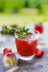 Delicious and refreshing smoothie with watermelon on the table in the garden. 