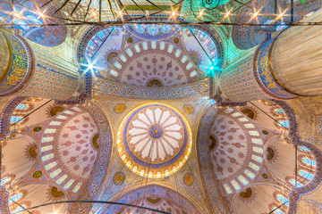 Interior decoration view and artworks of  Blue Mosque also called Sultan Ahmed Mosque or Sultan Ahmet Mosque in Istanbul, Turkey.Ceiling and domes decorations.