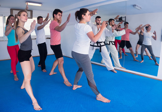  Adults Attempting To Master New Moves During Karate Class