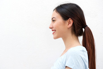 Side portrait of healthy young woman with long hair smiling
